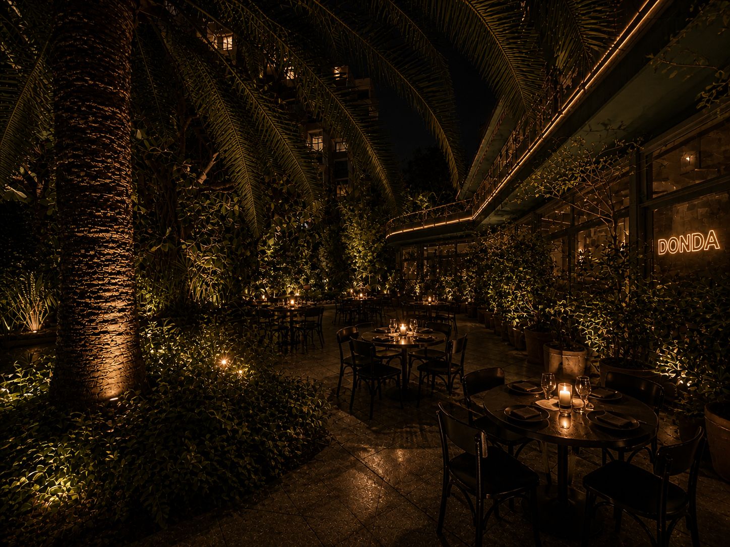 The Secret Garden at night — palms, candle-lit tables, DONDA neon glowing on the back wall